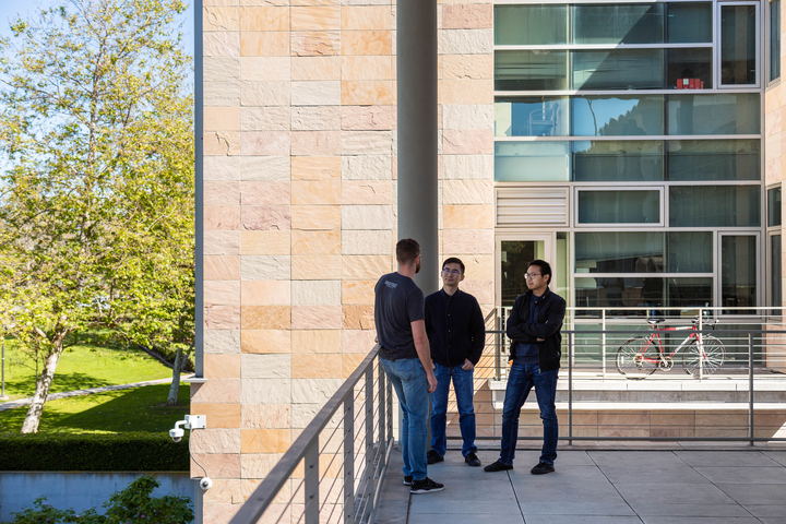 men outside building talking